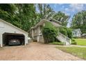 View of a charming home with a detached garage and lovely landscaping at 816 Fulton St, Albemarle, NC 28001