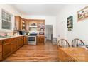 Vintage kitchen featuring wooden cabinets, stainless steel appliances, and vinyl wood-look flooring at 816 Fulton St, Albemarle, NC 28001