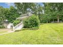 Expansive lawn and lovely landscaping surround this charming home's exterior at 816 Fulton St, Albemarle, NC 28001