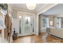 Bright entryway with hardwood floors, a decorative front door, and a view into the cozy living room at 827 Ashwyn Dr, Charlotte, NC 28211