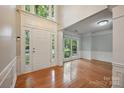 Bright foyer with hardwood floors and a grand entrance, enhanced by large windows and natural light at 8805 Deerland Ct, Huntersville, NC 28078