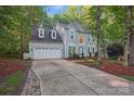Traditional two-story home featuring a two-car garage and well-maintained landscaping adds to its appeal at 8805 Deerland Ct, Huntersville, NC 28078