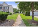 This home has a well maintained yard with an easily walkable path to other parts of the community at 8915 Merrie Rose Ave, Charlotte, NC 28213