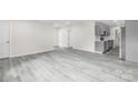 Spacious living area with sleek gray floors and stainless steel kitchen appliances at 1017 W Fisher St, Salisbury, NC 28144
