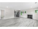 Open floor plan with gray floors, a fireplace, and stainless steel kitchen appliances at 1017 W Fisher St, Salisbury, NC 28144