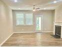 Bright living room with fireplace, ceiling fan, and ample windows at 10416 Audubon Ridge Dr # 4, Cornelius, NC 28031