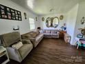 Spacious living room with wood flooring, neutral colors, comfortable seating and bright interior at 1050 Old Peachland Rd, Marshville, NC 28103