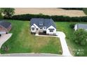 An aerial view of a home featuring a spacious driveway and large front yard at 115 Augusta Ln, Shelby, NC 28150