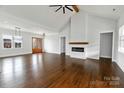 Open-concept living room with hardwood floors, fireplace, and a modern ceiling fan at 115 Augusta Ln, Shelby, NC 28150