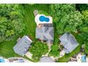 Aerial view of the property featuring a private pool, lush landscaping, and a well-maintained yard at 12002 Cobham Ct, Huntersville, NC 28078