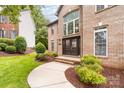 Inviting front entrance with a double door and well-maintained landscaping at 12002 Cobham Ct, Huntersville, NC 28078