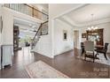 Elegant home foyer with hardwood floors, staircase, and views of the living and dining areas at 12410 Franklin Park Ln, Huntersville, NC 28078
