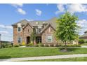 Charming home with brick facade, complemented by a well-maintained lawn and mature trees at 12410 Franklin Park Ln, Huntersville, NC 28078