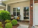 Inviting front porch with seating and lush landscaping, perfect for enjoying the outdoors at 146 Rapids Rd, Fort Mill, SC 29715