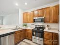 Well-equipped kitchen featuring stainless steel appliances and warm wood cabinets at 146 Rapids Rd, Fort Mill, SC 29715