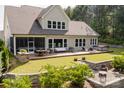 Expansive backyard featuring a large deck with hot tub, outdoor seating, fire pit, and well-maintained lawn at 15103 Cimarron Hills Ln, Charlotte, NC 28278