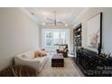 Cozy living room with modern lighting, stylish furniture, and large windows offering ample natural light at 15103 Cimarron Hills Ln, Charlotte, NC 28278