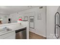Bright kitchen featuring stainless steel dishwasher, and white cabinetry at 1602 Eagles Pl # J103, Rock Hill, SC 29732