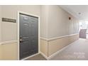 Condo hallway featuring unit number, carpeting, and staircase access at 16344 Redstone Mountain Ln, Charlotte, NC 28277