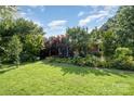 Charming home with manicured lawn and beautiful flowerbeds at 19924 Floral Ln, Cornelius, NC 28031