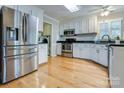 Modern kitchen featuring stainless steel appliances, granite countertops, and white cabinetry at 2043 Shadwell Ct, Gastonia, NC 28056