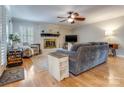 Inviting living room with a white brick fireplace, ceiling fan, and lots of natural light at 2043 Shadwell Ct, Gastonia, NC 28056
