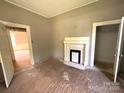 A room showcasing an original fireplace, high ceilings and potential for customization at 235 Jefferson E St, York, SC 29745