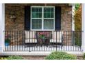 Inviting front porch with stone accents, comfortable seating, and decorative plants at 2405 Emma Grace Ln, Rock Hill, SC 29732