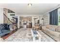 Open-concept living room with hardwood floors and views of the staircase and dining area at 2606 Cheverny Pl, Concord, NC 28027