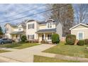 Attractive two-story home featuring a welcoming front porch, well-kept lawn, and appealing curb appeal at 2614 Ocracoke St, Charlotte, NC 28208