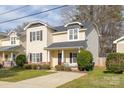 Inviting two-story home with classic design, tidy landscaping, and a pleasant neighborhood setting at 2614 Ocracoke St, Charlotte, NC 28208
