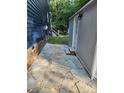 Stone pathway between house and shed, providing access to the backyard with lush greenery at 27092 Village Dr, Fort Mill, SC 29708