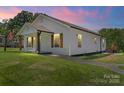 Beautiful single-story home with wood accents and a lush green lawn in a tranquil neighborhood at 321 E Taylor St, Landis, NC 28088
