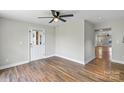 Bright, airy living room features modern ceiling fan, hardwood floors, and neutral paint, creating a cozy atmosphere at 321 E Taylor St, Landis, NC 28088
