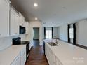 Modern kitchen featuring white cabinets, quartz countertops, and stainless steel appliances at 3629 Cerelia Ln, Denver, NC 28037