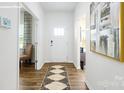 Bright foyer with wood flooring, white walls, and a decorative rug welcomes you home at 3735 Coleman Dr, Charlotte, NC 28215