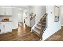 Elegant staircase with wooden railing and iron spindles, connecting to the upper level at 3735 Coleman Dr, Charlotte, NC 28215