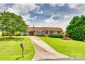 Exterior view of a brick ranch home with a long driveway and manicured lawn at 3903 Graywood Dr, Gastonia, NC 28052