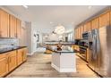 Open kitchen with island, granite counters, and stainless appliances that offers seamless flow into the adjacent living spaces at 5832 Lagrande Dr, Charlotte, NC 28269