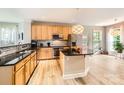 Kitchen features stainless steel appliances, granite countertops, a center island, and wood cabinets at 5832 Lagrande Dr, Charlotte, NC 28269