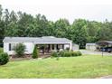 Well-maintained home featuring a covered front porch, manicured lawn, and ample parking at 6213 Golden Oak Ln, Denver, NC 28037