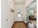 Bright foyer showcasing a decorative front door, coat rack, and view into the living room at 8035 Pastime Ln, Clover, SC 29710