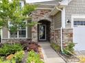 Inviting entryway featuring a stone archway, well-maintained landscaping, and a welcoming front door at 8035 Pastime Ln, Clover, SC 29710