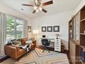 Cozy home office with a comfortable couch, modern desk setup, and ample natural light at 8035 Pastime Ln, Clover, SC 29710