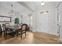 Bright dining room featuring wood floors, modern lighting, and a doorway to welcome guests at 82120 Standing Oak Dr, Charlotte, NC 28278