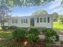 Charming home with mature landscaping and a welcoming front entrance at 908 Mccollough St, Statesville, NC 28677