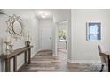 Inviting entryway with hardwood floors, a stylish mirror, and views into other rooms at 10111 Snowbell Ct, Charlotte, NC 28215