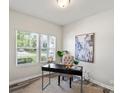 Bright office space with a large window, modern desk, and calming decor at 10111 Snowbell Ct, Charlotte, NC 28215