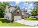 Charming two-story home with stone and vinyl siding, featuring manicured lawn and flower boxes adding to curb appeal at 10129 Loch Lomond Dr, Charlotte, NC 28278