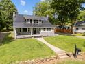 Attractive home showcasing a metal roof, covered porch with a swing, and a stone walkway through the green lawn at 1025 Old Us 80 Hwy, Gold Hill, NC 28071